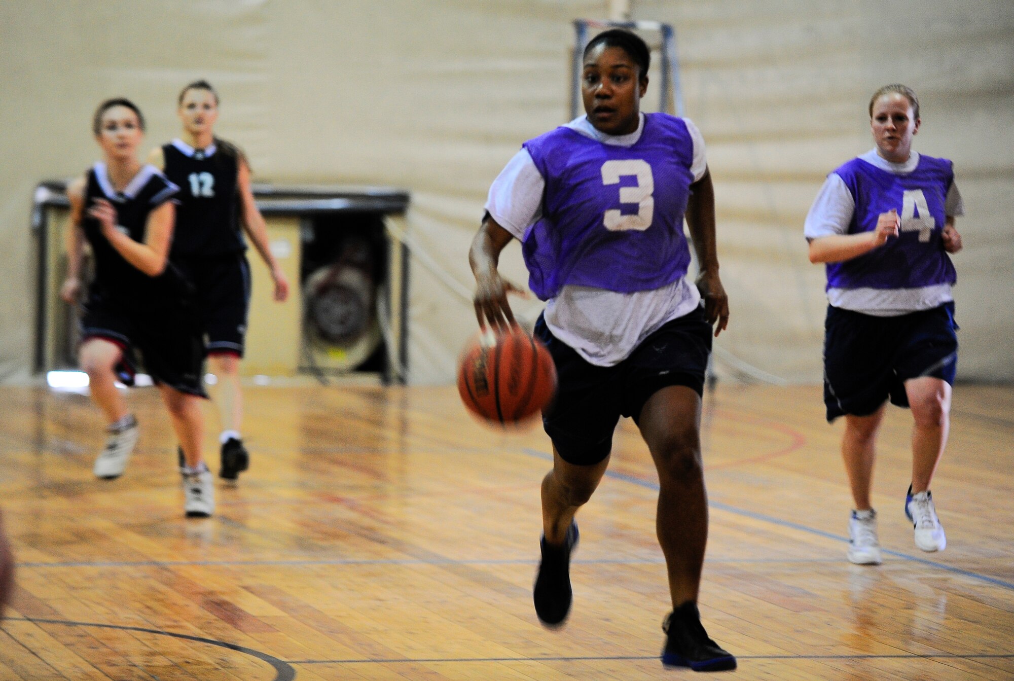 Staff Sgt. Charlotte Jones dribbles a basketball down the court March 3, 2012, during a Kyrgyz ans American friendship basketball game at the Transit Center at Manas, Kyrgyzstan. The game was held to celebrate International Women's Day March 8. Jones is the 376th Expeditionary Force Support Squadron A'la-Too dining facility storeroom NCO in charge. She is deployed here from Little Rock Air Force Base, Ark. (U.S. Air Force Photo/Staff Sgt. Angela Ruiz)