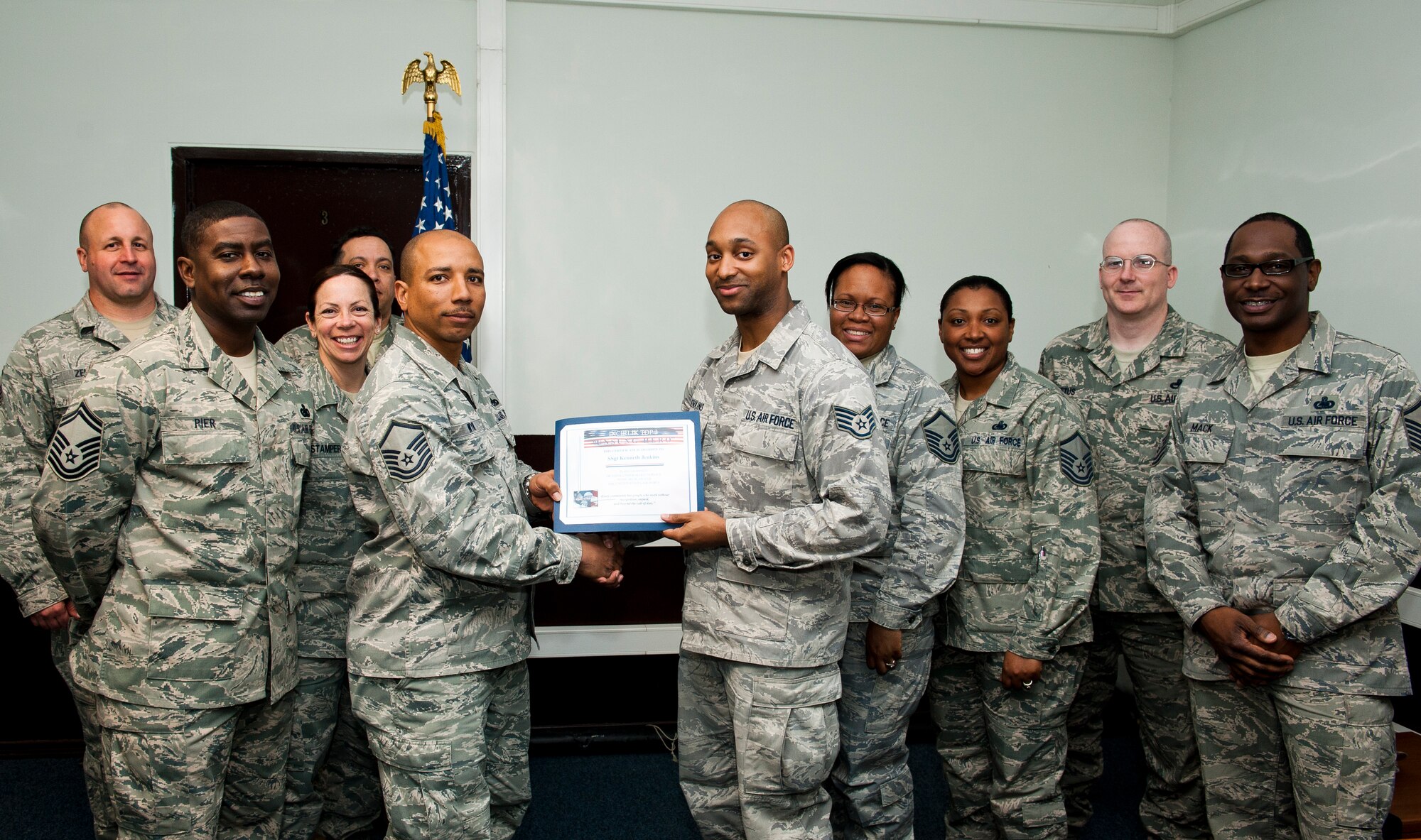 Staff Sgt. Kenneth Jenkins, 39th Maintenance Squadron, receives the Unsung Hero Award from the Incirlik Top 3 organization March 2, 2012, at Incirlik Air Base, Turkey. The Top 3 presents the Unsung Hero Award monthly to an Airman demonstrating superior job performance and exceptional leadership. (U.S. Air Force photo by Tech. Sgt. Michael B. Keller/Released)