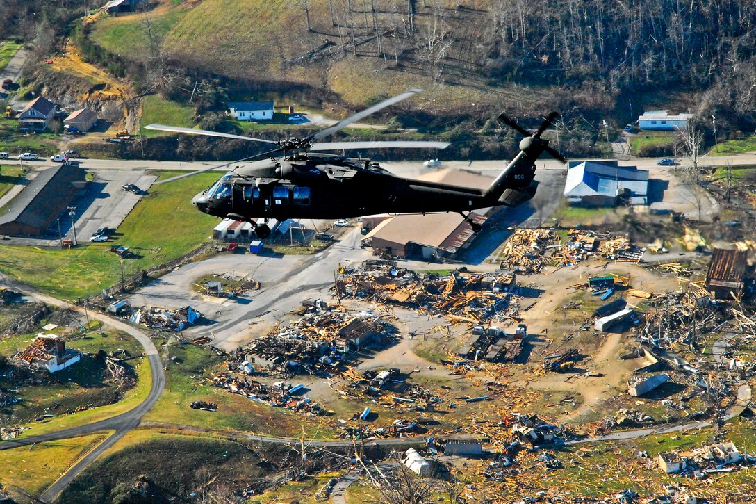 An Army UH-60 Black Hawk helicopter carries Kentucky Gov. Steve Beshear as he views damage in West Liberty, Ky., March 3, 2012, after a tornado hit the town the previous day. Approximately 220 Kentucky National Guardsmen assisted post-weather efforts in five counties in eastern Kentucky as a result of tornados that struck the area.