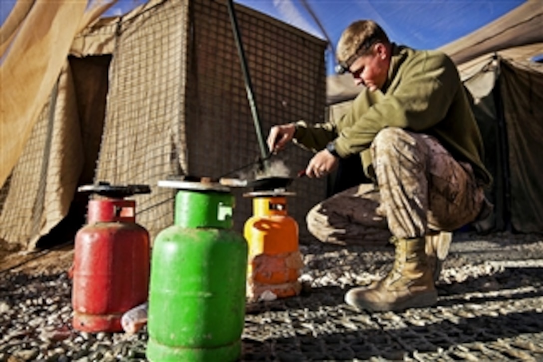 U.S. Marine Corps Lance Cpl. Tom Morton cooks eggs for breakfast before beginning his duties at Patrol Base Bury in the Garmsir district of Afghanistan's Helmand province on Feb. 25, 2012.  Morton is a team leader assigned to Kilo Company, 3rd Battalion, 3rd Marine Regiment. 