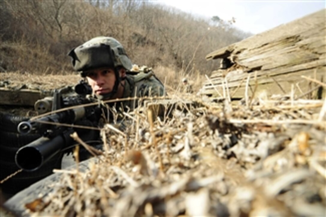 U.S. Marine Corps Lance Cpl. Mario Melendez, assigned to Fleet Antiterrorism Security Team Pacific, stands guard as fellow Marines clear a trench in a tactical movement exercise at Camp Rodriguez, South Korea, on March 1, 2012.  Marines assigned to the antiterrorism security team trained at the Camp Rodriguez live fire complex during the exercise.  