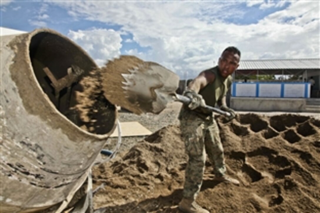 U.S. Marine Corps Staff Sgt. Mario Vargas shovels concrete mix into a cement barrel mixer outside an elementary school being built in Caracol, Haiti, Feb. 29, 2012. Vargas is assigned to the Marine Corps detachment embarked aboard High Speed Vessel 2 Swift. The HSV 2 Swift is currently taking part in Southern Partnership Station 2012, a deployment of U.S Naval assets in the Caribbean, Central and South America.