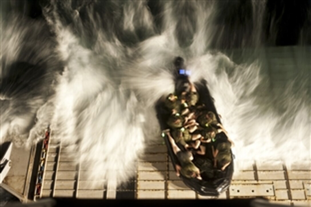 U.S. Marines recover at the stern gate of the amphibious dock landing ship USS Tortuga after a night exercise in a combat rubber raiding craft under way in the U.S. 7th Fleet area of responsibility, March 1, 2012. The Marines are assigned to the 31st Marine Expeditionary Unit. 