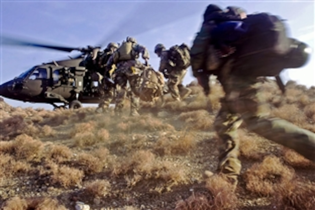 Afghan commandos sprint to board a U.S. Army UH-60 Black Hawk helicopter during a mission in the Chawkai district in Afghanistan's Kunar province, Feb. 25, 2012. The commando-led mission was to conduct reconnaissance for a future village stability platform where Afghan forces and coalition special operations forces can live and work with villagers.