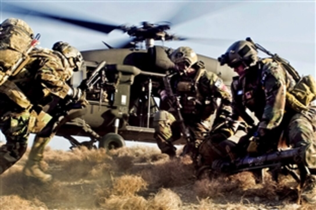 Coalition special operations forces sprint to board a U.S. Army UH-60 Black Hawk helicopter during a mission in the Chawkai district in Afghanistan's Kunar province, Feb. 25, 2012. Afghan commandos led the mission, which conducted reconnaissance for future stability to enable U.S. and Afghan forces to live and work with villagers.