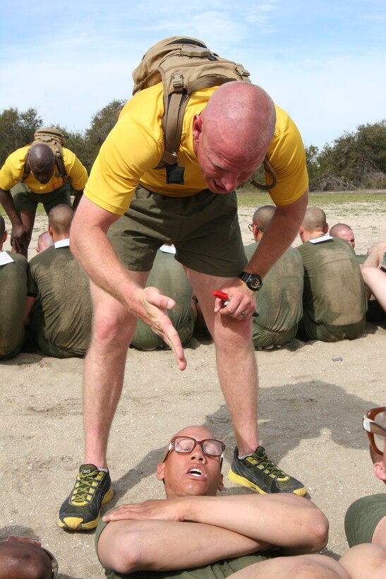Sgt. Daniel C. Downing, drill instructor, Company G., 2nd Recruit Training Battalion motivates recruit Aaron G. Real, Co. G, 2nd RTBn. during an inventory physical fitness test March 5 aboard Marine Corps Recruit Depot San Diego. For 12 weeks of recruit training, men who accept the challenge of becoming Marines are put through numerous physical strains to help them increase their final PFT scores.