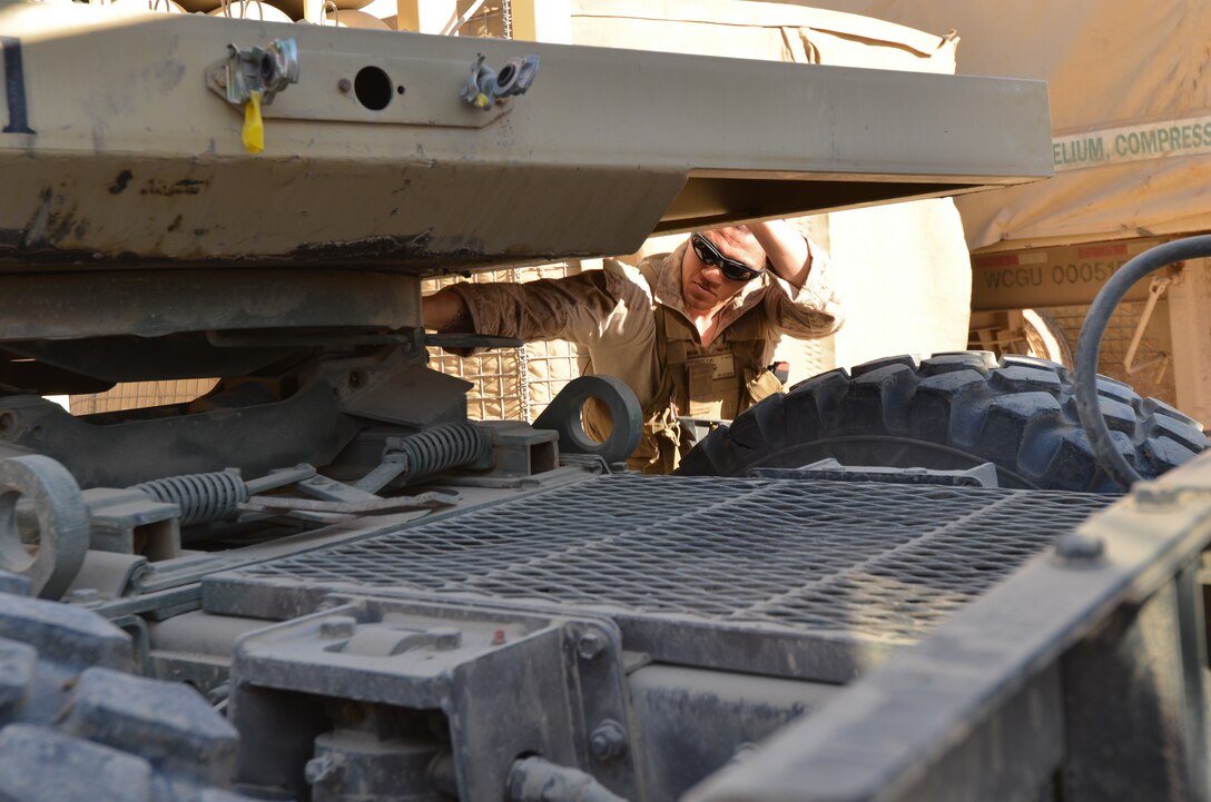 Lance Cpl. Samuel Depriest, a military policeman, Combat Logistics Battalion 4, 1st Marine Logistics Group (Forward), detaches a trailer loaded with compressed helium during supply offload operations at Forward Operating Base Pennsylvania, March 5. The lighter-than-air gas was used to fill surveillance blimps that monitor the area around the FOB.