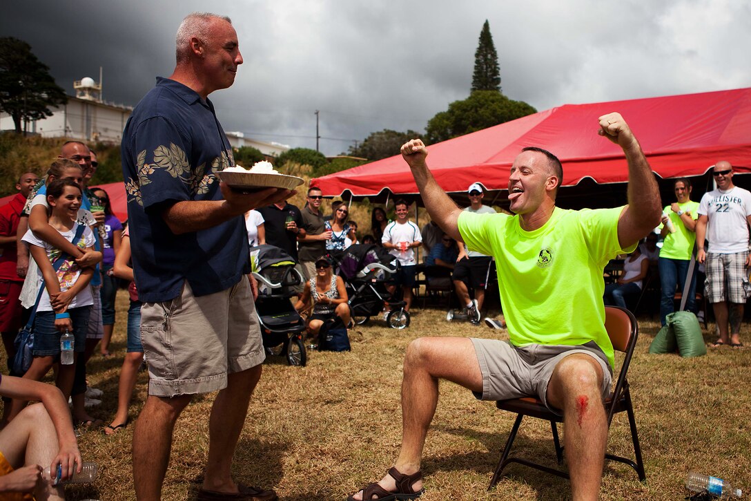 CAMP H.M. SMITH, Hawaii-Col. Brent S. Willson, the commanding officer, Headquarters and Service Battalion, U.S. Marine Corps Forces, Pacific, prepares to put a pie in the face of Maj. Jan-Hendrick C. Zurlippe, officer-in-charge, comptroller section, HqSvcBn, at the Bordelon Bash at Bordelon Field here Oct 7. The Bordelon Bash was a family fun day event hosted by the battalion.