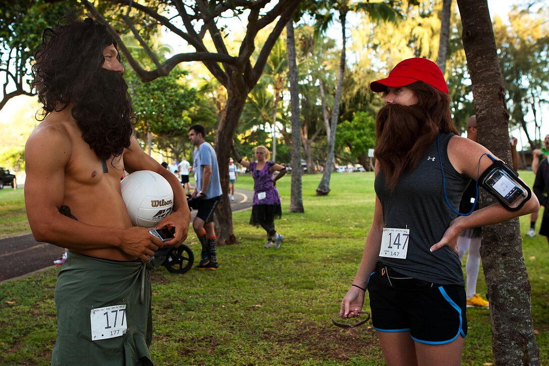 KAILUA, Hawaii-Staff Sgt. Andres A. Trujillo, a U.S. Marine Corps Forces, Pacific Band member dressed as “Cast Away” character Chuck Noland, meets another Tom Hanks impersonator, Sarah L. Mitson, an Oahu resident dressed as Forrest Gump, at the 2nd Annual General “Howlin’ Mad” Smith 5k here Oct. 29. Headquarters and Service Battalion, MarForPac, hosted the race as a fundraiser for the MarForPac birthday ball.
