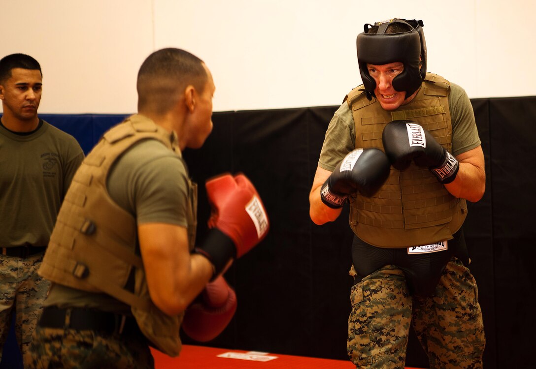 CAMP H.M. SMITH, Hawaii -Lt. Col. Chris A. Feyedelem (right), head of the plans and operations branch, logistics section, U.S. Marine Corps Forces, Pacific, spars with Sgt. Corey Etibek, a Marine Corps Martial Arts Program instructor who works at Pacific Command, at the MCMAP room here Nov. 16. Sparring is a part of physical training in the current MCMAP course taught here Nov. 14-23.