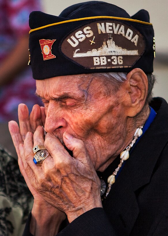 PEARL HARBOR, Hawaii-Ernie Mattson, a 96-year-old Pearl Harbor survivor, plays old war tunes on his harmonica for an attentive crowd after the 70th Annual Pearl Harbor Day Commemoration at Pearl Harbor on Dec. 7. “I’ve never smoked, or drinked and that’s why I have more wind than people half my age,” he shouted to the crowd who he impressed with his skills.