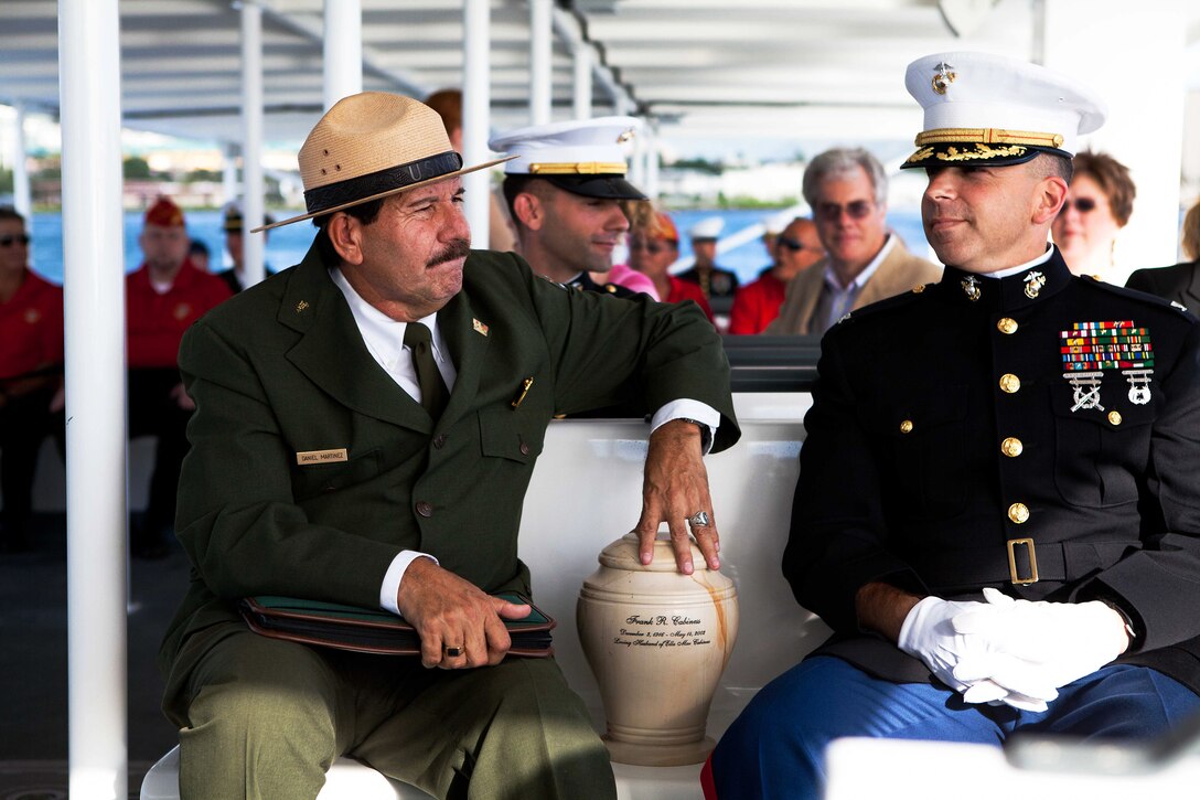 PEARL HARBOR, Hawaii-Daniel Martinez (left), a chief historian for Hawaii’s National Park Service, and Col. Nathan Nastase (right), commanding officer of 3rd Marine Regiment, escort Frank R. Cabiness’ urn to the USS Arizona Memorial here Dec. 23 for his interment ceremony. Cabiness was a part of the Marine detachment aboard the USS Arizona and survived the attacks on Pearl Harbor on Dec. 7, 1941. 