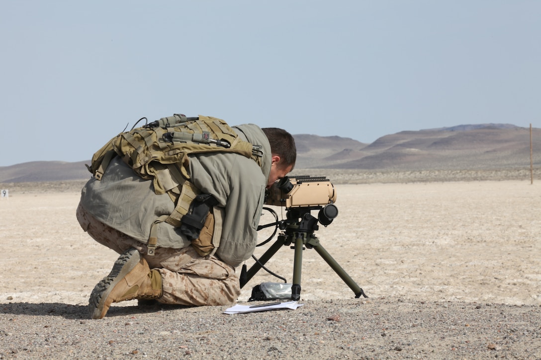 Joint Terminal Attack Controller with U.S. Marine Corps Forces, Special Operations Command looks through a SOF Laser Marker to provide a laser mark on a target for supporting aircraft during Carrier Airwing Training conducted by the Naval Strike and Air Warfare Center aboard Naval Air Station Fallon, Nev., April 14. During the exercise, MARSOC JTACs practiced their critical skills and renewed their currencies and qualifications. 