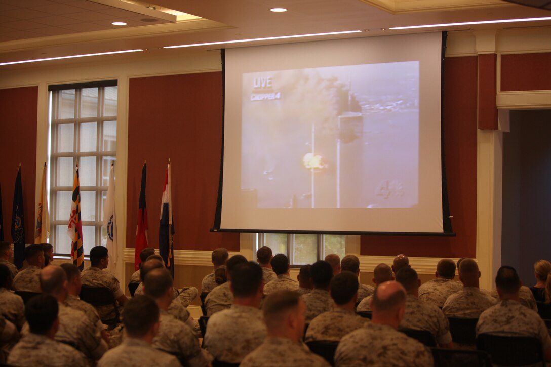 Marines and Sailors of 3d Marine Special Operations Battalion, U.S. Marine Corps Forces, Special Operations Command, watch old news footage of 9/11 at a memorial ceremony aboard Camp Lejeune, N.C. Sept.7. September was a month of rememberance and reflection, marked by several ceremonies taking place throughout MARSOC to honor its fallen warriors and the victims of 9/11.