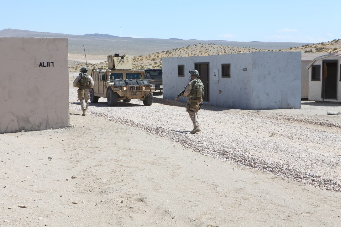 Marines with U.S. Marine Corps Forces, Special Operations Command, patrol through a village during a pre-deployment exercise at the National Training Center, Fort Irwin, Calif. May 15, 2011. The three-week exercise is designed to prepare MARSOC Marines for deployment to combat operations in Afghanistan by immersing them in an environment as realistic and comprehensive as possible. (Official U.S. Marine Corps photo by Cpl. Kyle McNally/Released)