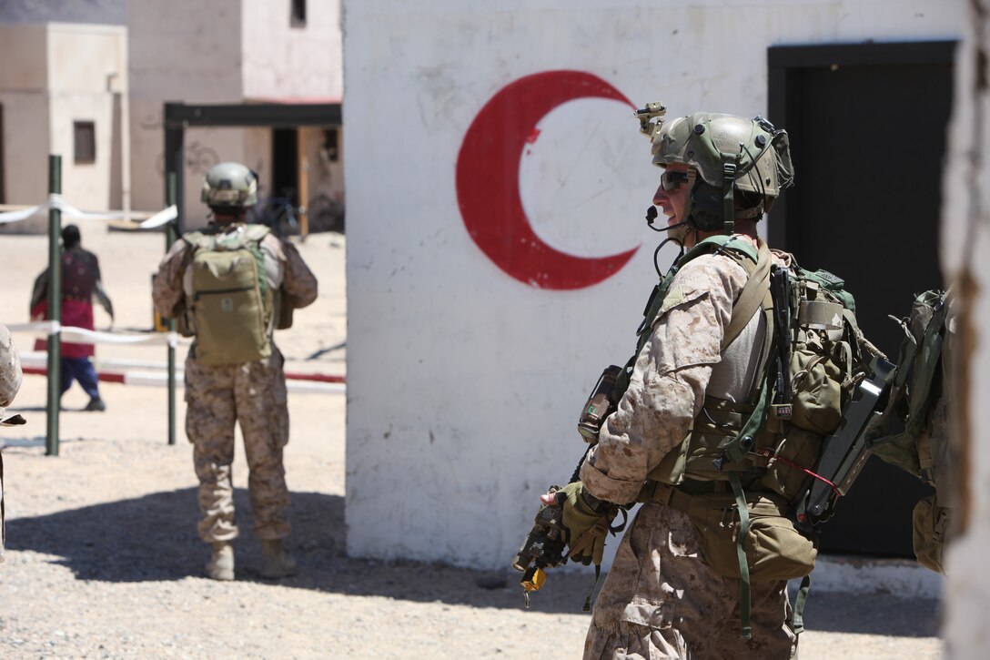 Marines with U.S. Marine Corps Forces, Special Operations Command, provide security during a medical engagement as part of a pre-deployment exercise at the National Training Center, Fort Irwin, Calif., May 15. The three-week exercise is designed to prepare MARSOC Marines for deployment to combat operations in Afghanistan by immersing them in an environment as realistic and comprehensive as possible.