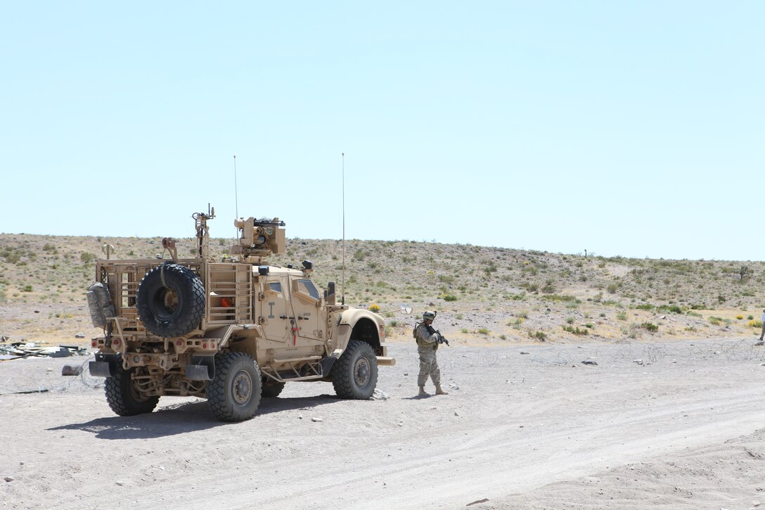 A soldier attached to U.S. Marine Corps Forces, Special Operations Command, provides security outside of a village during a pre-deployment exercise at the National Training Center, Fort Irwin, Calif. May 15, 2011. The three-week exercise is designed to prepare MARSOC Marines for deployment to combat operations in Afghanistan by immersing them in an environment as realistic and comprehensive as possible.