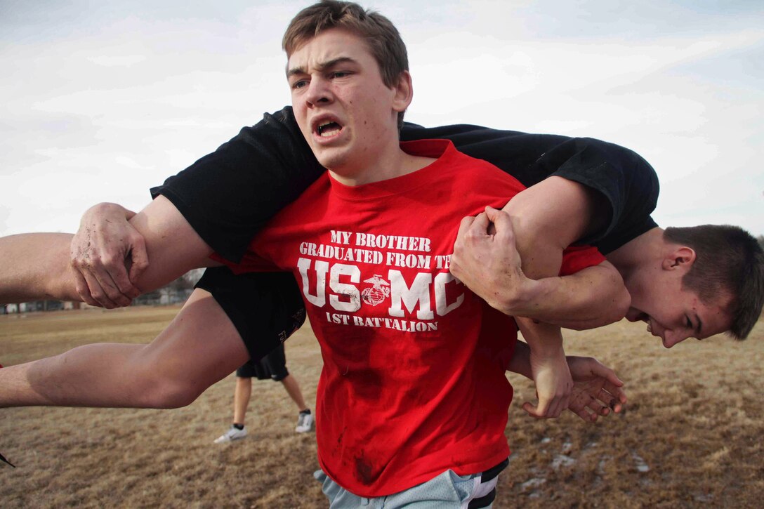 Ryan Wolke, a 15-year-old freshman, carries fellow Belle Plaine High School athlete, Danny McCann, during a modified combat fitness test March 6. More than 65 students in grades seven through 12 participated in the event, which was hosted by Recruiting Substation Burnsville. Wolke's brother, Kyle, graduated from boot camp in September 2011. For additional imagery from the event, visit www.facebook.com/rstwincities.