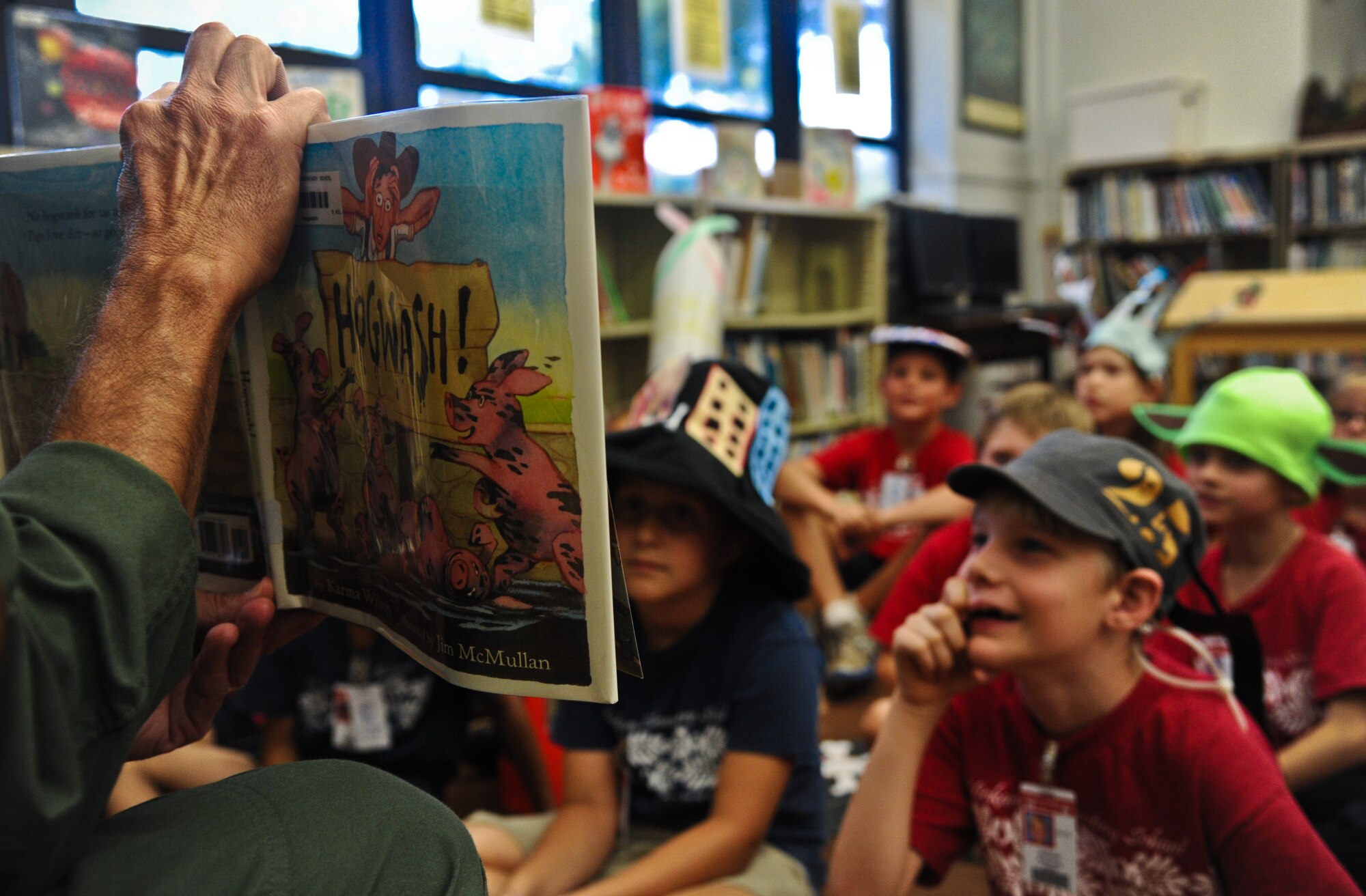 Col. Joe Dague, 15th Wing vice commander, reads a book to a kindergarten class March 1 at Hickam Elementary on Joint Base Pearl Harbor-Hickam, Hawaii. Dague read to the children as part of the Read Across America program honoring Dr. Seuss' birthday March 2. (U.S. Air Force photo/Senior Airman Lauren Main)