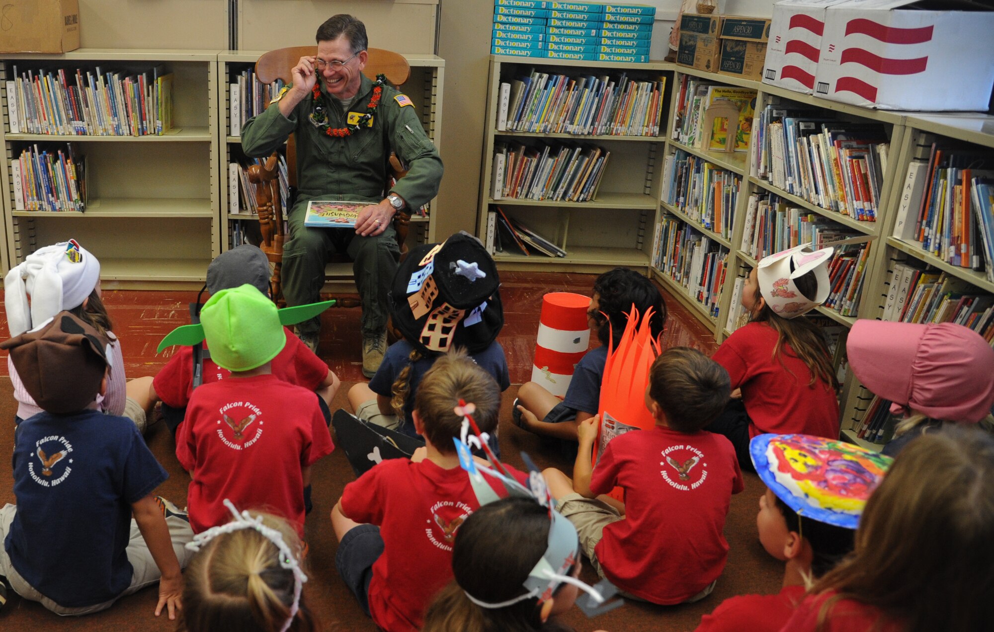 Col. Joe Dague, 15th Wing vice commander, reads a book to a kindergarten class March 1 at Hickam Elementary on Joint Base Pearl Harbor-Hickam, Hawaii. Dague read to the children as part of the Read Across America program honoring Dr. Seuss' birthday March 2. (U.S. Air Force photo/Senior Airman Lauren Main)