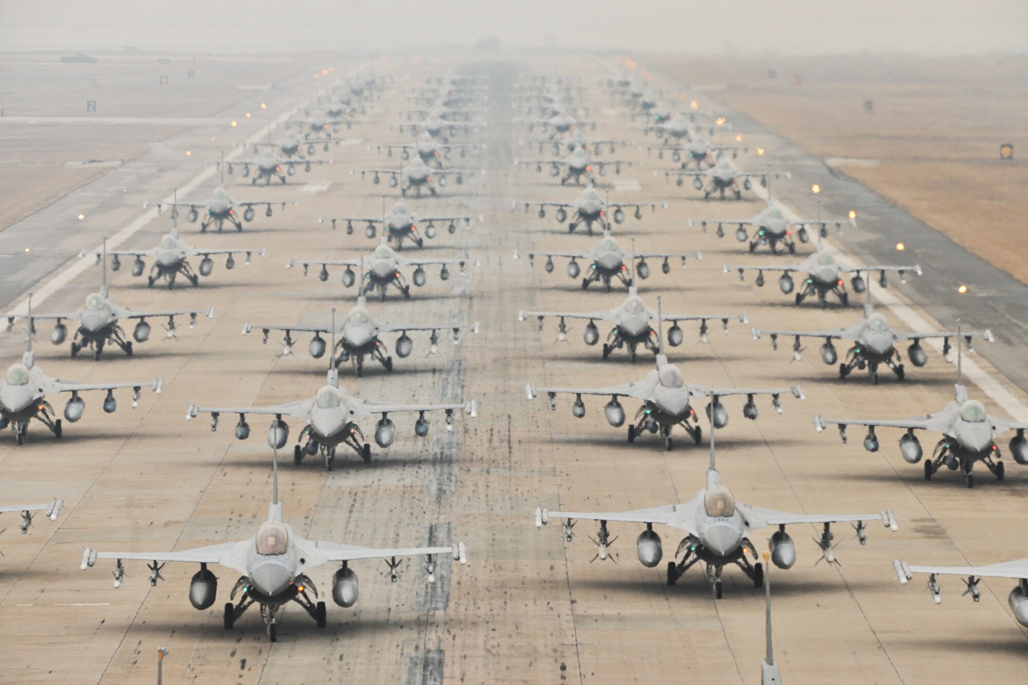 F-16 Fighting Falcons from the 35th and 80th Fighter Squadrons of the 8th Fighter Wing, Kunsan Air Base, Republic of Korea; the 421st Expeditionary Fighter Squadron of the 388th FW at Hill Air Force Base, Utah; the 55th EFS from the 20th FW at Shaw AFB, S.C.; and from the 38th Fighter Group of the ROK Air Force, demonstrate an “Elephant Walk” as they taxi down a runway during an exercise at Kunsan Air Base, Republic of Korea, March 2, 2012. The exercise showcased Kunsan AB aircrews' capability to quickly and safely prepare an aircraft for a wartime mission. (U.S. Air Force photo by Senior Airman Brittany Y. Auld/Released)
