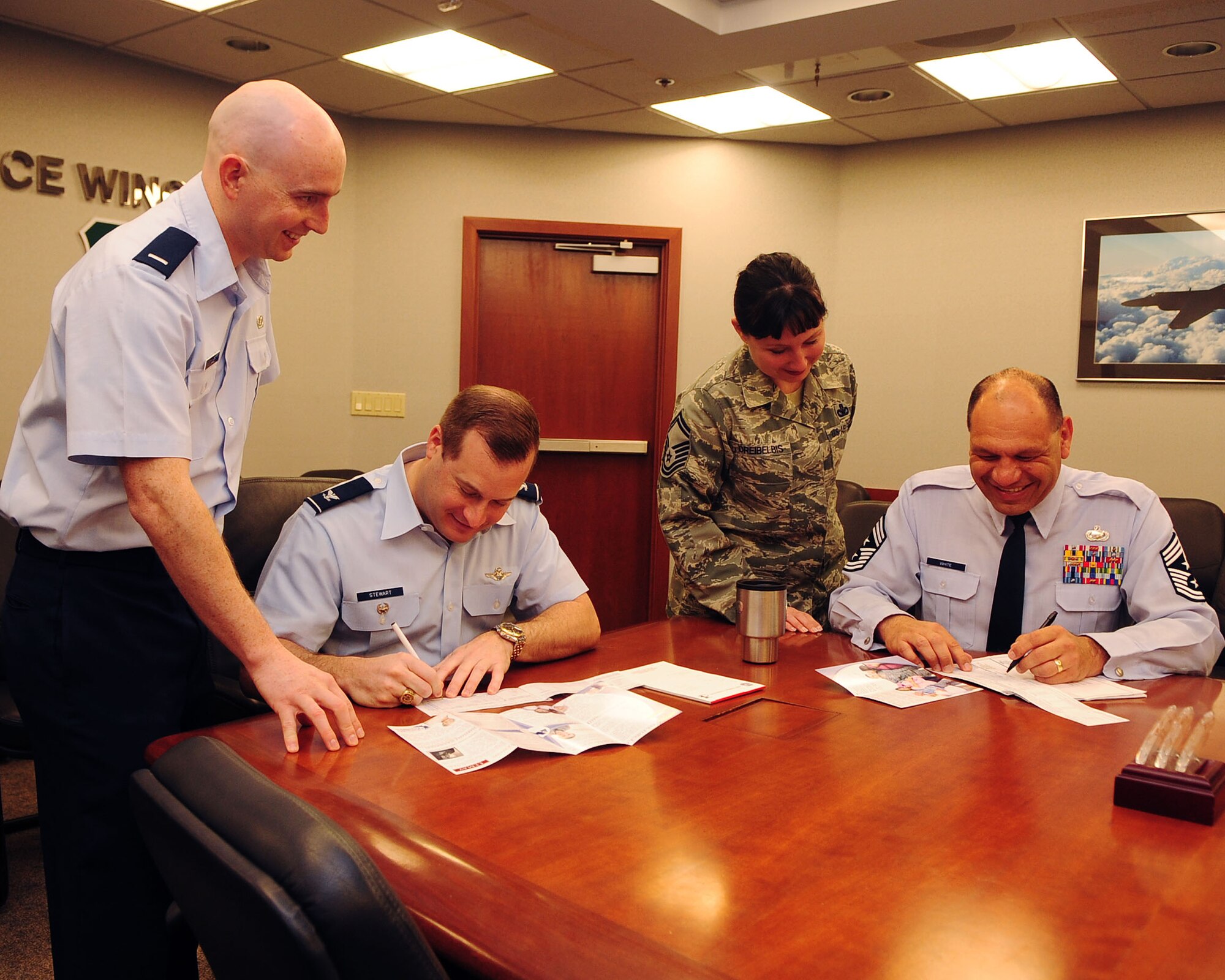 Col. Phillip Stewart, 9th Reconnaissance Wing (RW) vice commander, and Chief Master Sgt. Robert White, 9 RW command chief, fill out Air Force Assistance Fund (AFAF) pledges while 1st Lt. Jeremy Miller and Senior Master Sgt. Geri Dreibelbis, Installation Project Officers for AFAF, assist them at Beale Air Force Base, Calif. March 5, 2012.  The Air Force Assistance Fund is a program designed to raise money to assist Beale Airmen during times of need.  (U.S. Air Force photo by Staff Sergeant Jonathan Fowler/Released)