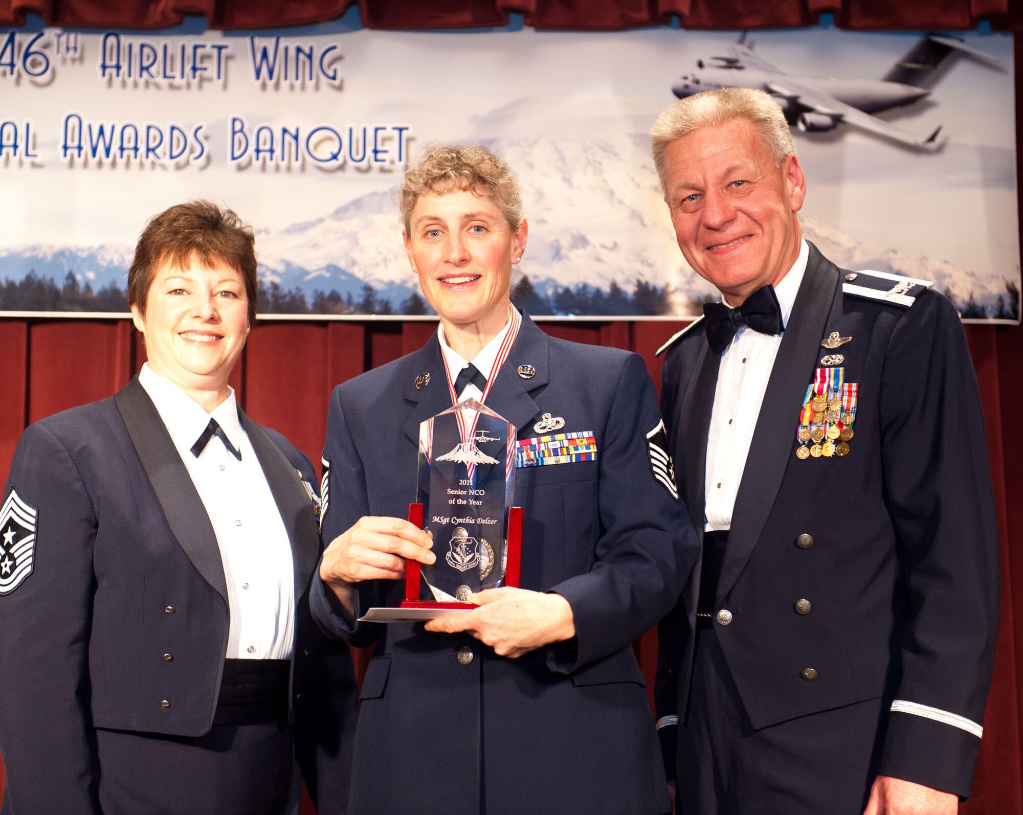 Master Sgt. Cynthia Delzer, 446th Maintenance Squadron, grins proudly as she receives her Senior Noncommissioned Officer of the Year award at the 446th Airlfit Wing's annual Awards Banquet March 3. (U.S. Air Force photo by Master Sgt. Eliezer Yamzon) 