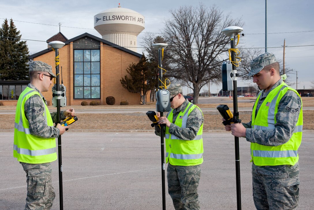 Airmen 1st Class Michael Rusnak, Jacob Mason and Robert Corfield, 28th Civil Engineer Squadron survey technicians, prepare to collect geographic coordinate data with survey rods and global positioning systems technology at Ellsworth Air Force Base, S.D., March. 6, 2012. Information is recorded and collected with GPS devices to ensure the most accurate, up-to-date map of the base are available. (U.S. Air Force photo by Airman 1st Class Zachary Hada/Released)