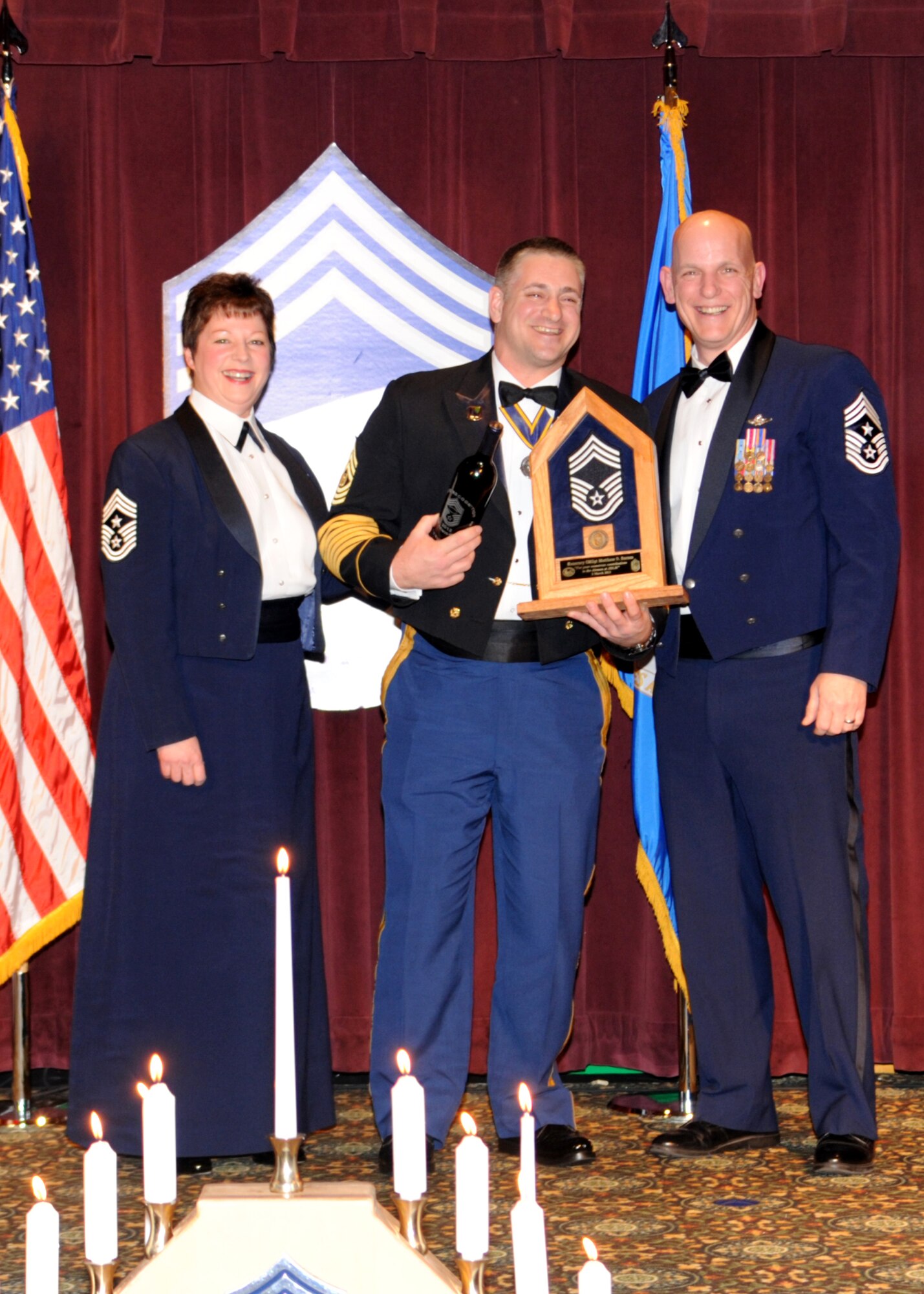 Chief Master Sgt. Gloria Bennett, left, 446th Airlift Wing command chief, and Command Chief Master Sgt. Gregory Warren, right, 62nd Airlift Wing command chief, present Command Sgt. Maj. Matthew Barnes, Joint Base Lewis-McChord garrison command sergeant major, with the Honorary Command Chief plaque during a Chief’s Recognition Ceremony March 2, 2012, at Joint Base Lewis-McChord, Wash. (U.S. Air Force photo/Master Sgt. Chris Haylett)