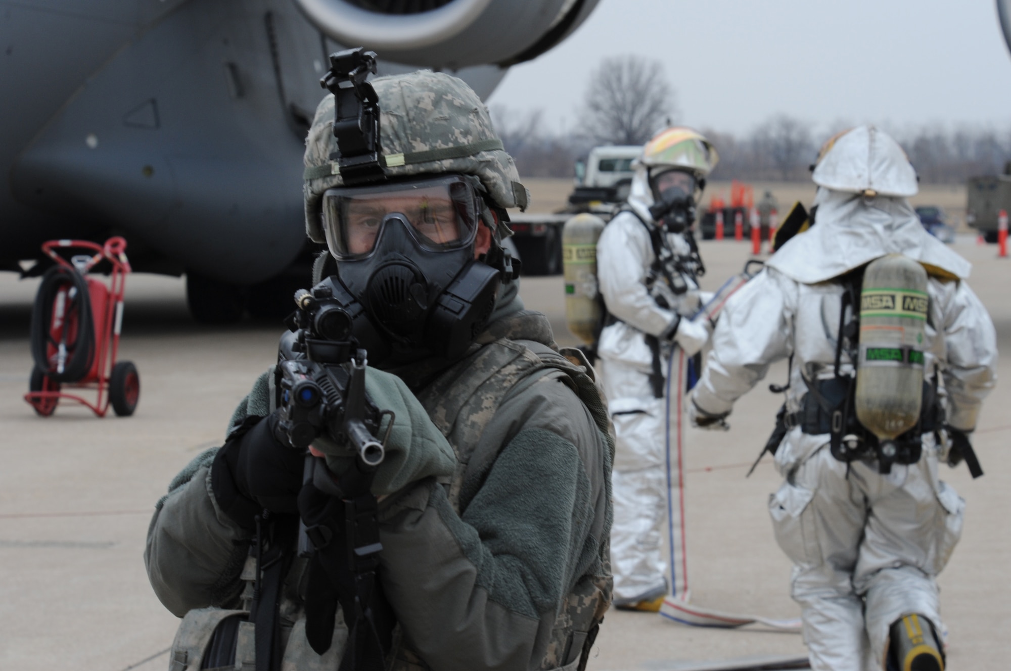 WHITEMAN AIR FORCE BASE, Mo. -- A member of the 509th Security Forces Squadron stands guard by a C-17 Globemaster during a Nuclear Surety Inspection Jan. 21. Whiteman finished the NSI with 22 teams and 27 individuals recognized as superior performers.