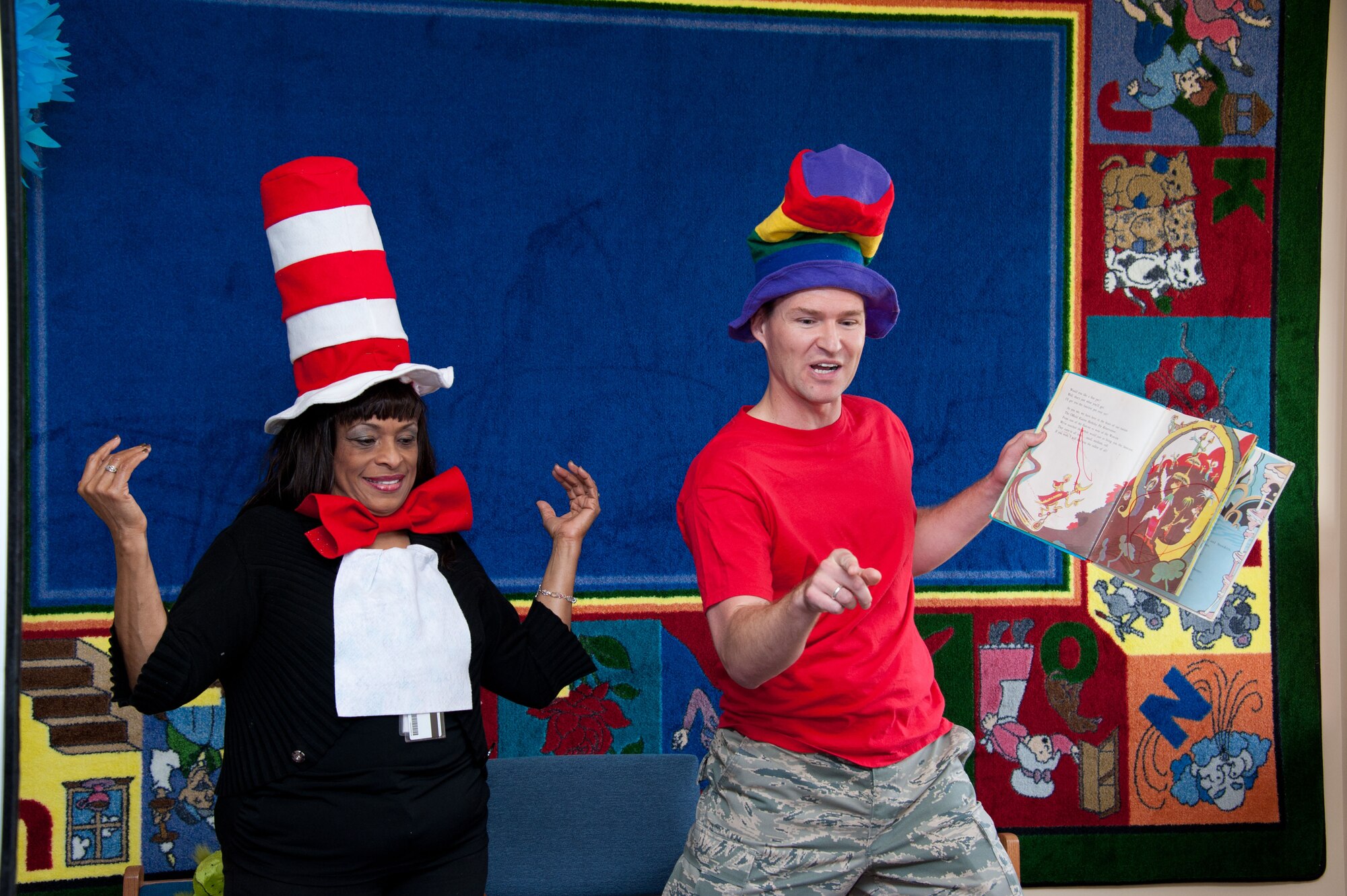 Master Sergeant Ricky Higby performs a special reading of Dr. Seuss for children at the Maxwell Community Library (bldg 910) on March 2, 2012. Deborah "Cat in the Hat" White also made an appearance.  (U.S. Air Force photo by Melanie Rodgers Cox)