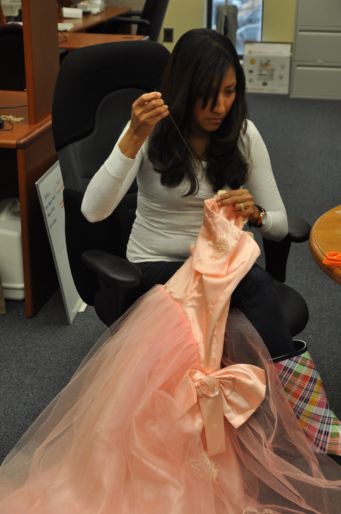 Belki Padilla aides the Columbus Spouse’s Club’s preparation for the Columbus Spring Pilgrimage by helping to create a dress.  The CSC has over 75 dresses that they’ve repaired or created for the hostesses of the upcoming Pilgrimage to wear.  (U.S. Air Force Photo/Airman 1st Class Charles Dickens)