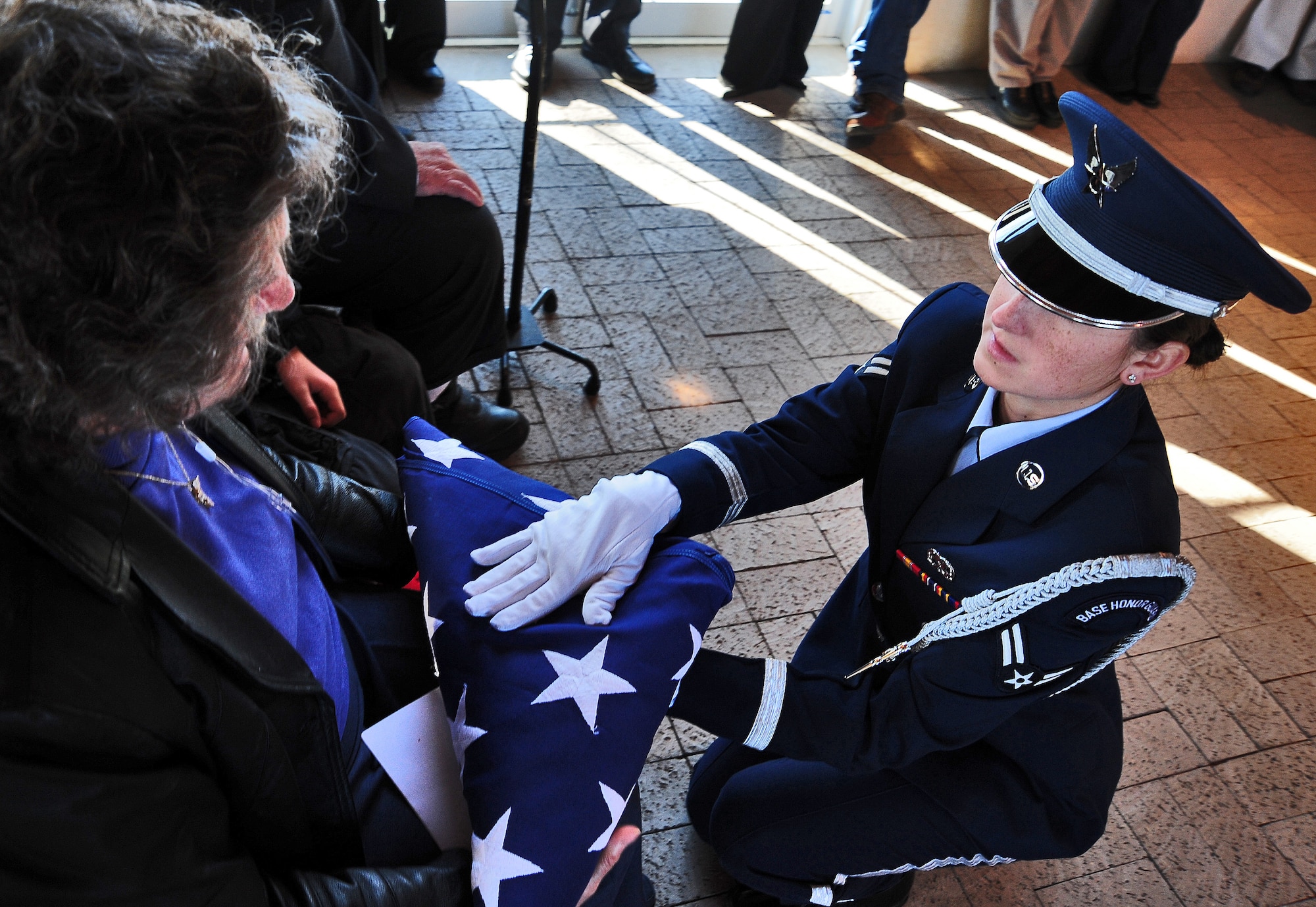 HIGGINSVILLE, Mo. -- Airman 1st Class Hope Pacheco, 509th Bomb Wing Honor Guard, gives a folded American flag to the family member of a fallen Airman during a funeral at the Veteran’s Cemetery Jan. 10. With a team of 44 Airmen ranking from airman basic to technical sergeant, the 509th BW Honor Guard has a mission that covers the state of Missouri to include 118 counties. (U.S. Air Force photo/Senior Airman Nick Wilson)