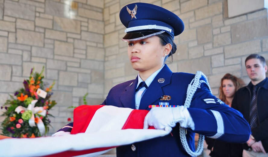 HIGGINSVILLE, Mo. -- Senior Airman Maichelle Ring, 509th Bomb Wing Honor Guard member, folds the American flag during a funeral at the Veteran’s Cemetery Jan. 10. With a team of 44 Airmen ranking from airman basic to technical sergeant, the 509th BW Honor Guard has a mission that covers 118 counties. (U.S. Air Force photo/Senior Airman Nick Wilson)