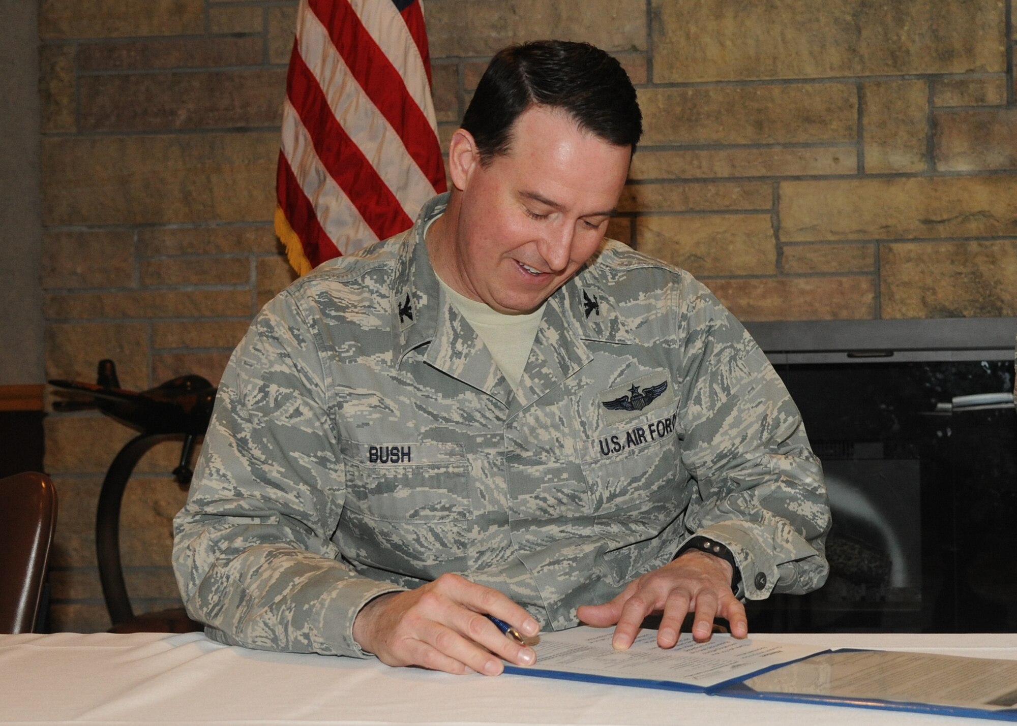 Col. Tim Bush, 319th Air Base Wing commander, signs up as an honorary member of the Air Force Sergeants Association on March 6, 2012, on Grand Forks Air Force Base, N.D. The AFSA is a federally chartered, non-profit organization “representing the professional and personal interests of active duty, retired and veteran Total Air Force and their families.” Anyone interested in joining the organization at Grand Forks can contact Master Sgt. Normal Becker via e-mail or at DSN 362-3705. (U.S. Air Force Photo by Airman 1st Class Ashley
N. Taylor)