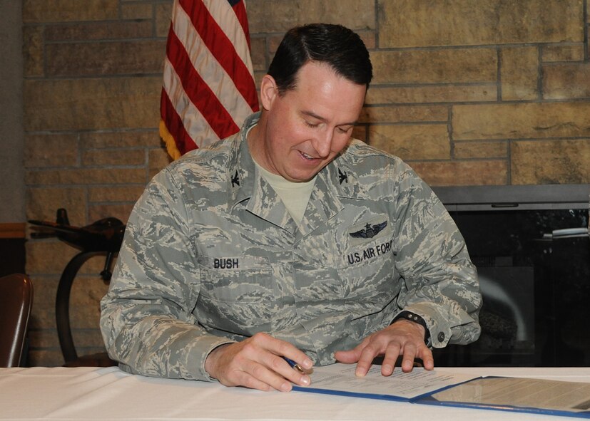 Col. Tim Bush, 319th Air Base Wing commander, signs up as an honorary member of the Air Force Sergeants Association on March 6, 2012, on Grand Forks Air Force Base, N.D. The AFSA is a federally chartered, non-profit organization “representing the professional and personal interests of active duty, retired and veteran Total Air Force and their families.” Anyone interested in joining the organization at Grand Forks can contact Master Sgt. Normal Becker via e-mail or at DSN 362-3705. (U.S. Air Force Photo by Airman 1st Class Ashley
N. Taylor)