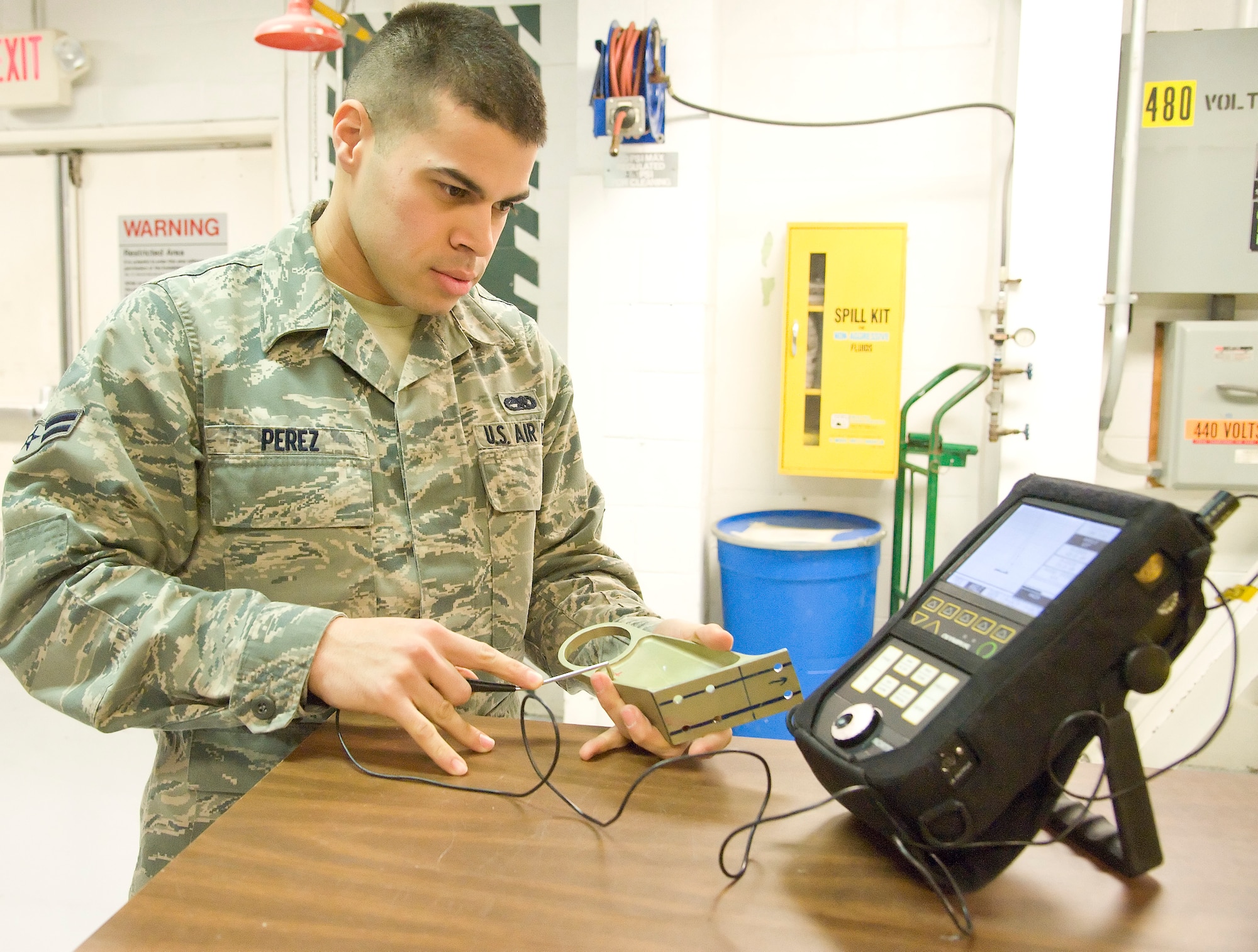 Airman 1st Class Emmanual Perez, a non-destructive inspector with the 436th Fabrication Flight, uses an eddy current to inspect for cracks at Dover Air Force Base, Dover, Del., Feb. 17, 2012. The Fabrication Flight performs the inspection and repair of aircraft system components. (U.S. Air Force photo by Adrian R. Rowan)
