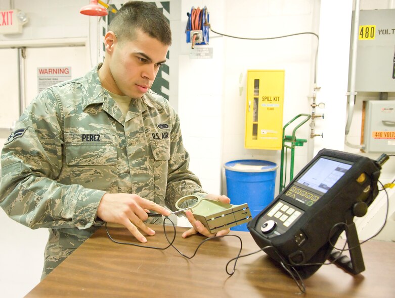Airman 1st Class Emmanual Perez, a non-destructive inspector with the 436th Maintenance Squadron Fabrication Flight, uses an eddy current to inspect for cracks at Dover Air Force Base, Dover, Del., Feb. 17, 2012. The Fabrication Flight performs the inspection and repair of aircraft system components. (U.S. Air Force photo by Adrian R. Rowan) 

