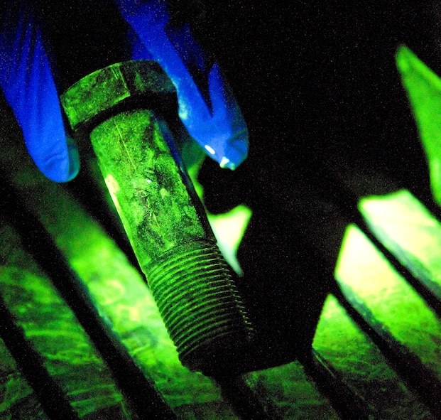 A bolt undergoes a penetrant inspection at Dover Air Force Base, Dover, Del., Feb. 17, 2012. The Fabrication Flight performs the inspection and repair of aircraft system components. (U.S. Air Force photo by Adrian R. Rowan)