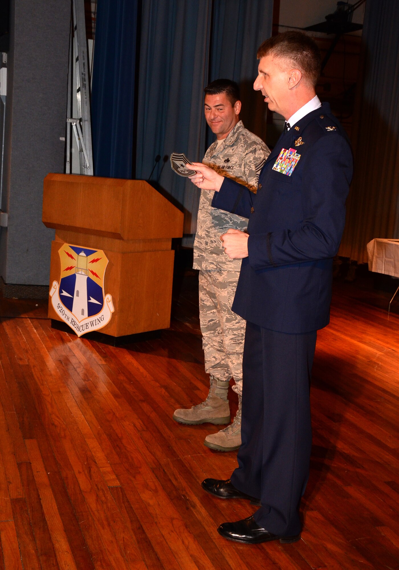 Col. Jeffrey Macrander, 920th Rescue Wing Commander, hands over the responsibility of the 'eyes and ears' of the enlisted force to Chief Master Sgt. Timothy Bianchi during wing commander's call March 4. With a star to top off his eight stripes, Bianchi will wear the top enlisted rank in the wing. Bianchi replaces Command Chief Master Sgt. Gerald Delebreau who held the position since April 16, 2008. Delebreau is leaving for a new job at the Pentagon as the Chief Enlisted Advisor for the National Guard and Reserve Manager. While Delebreau was deployed to Iraq from April 2011 through December 2011, Bianchi was appointed as the interim command chief. "It is my honor and privilege to serve the Airmen here at the 920th Rescue Wing," Bianchi said during his acceptance speech. "I look forward to continually building the relationship between the enlisted and officer corp." Bianchi's new rank will take effect March 15. (U.S. Air Force photo/2nd Lt. Leslie Forshaw)