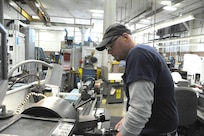 Rob Wooley, 902nd Mission Support Group Trainer Development Division, uses a lathe to turn down a small part for a Barany Chair on Joint Base San Antonio-Randolph March. 5. JBSA-Randolph manufactures the Barany Chair for all of the Defense Department.(U.S. Air Force photo by Rich McFadden) (released)