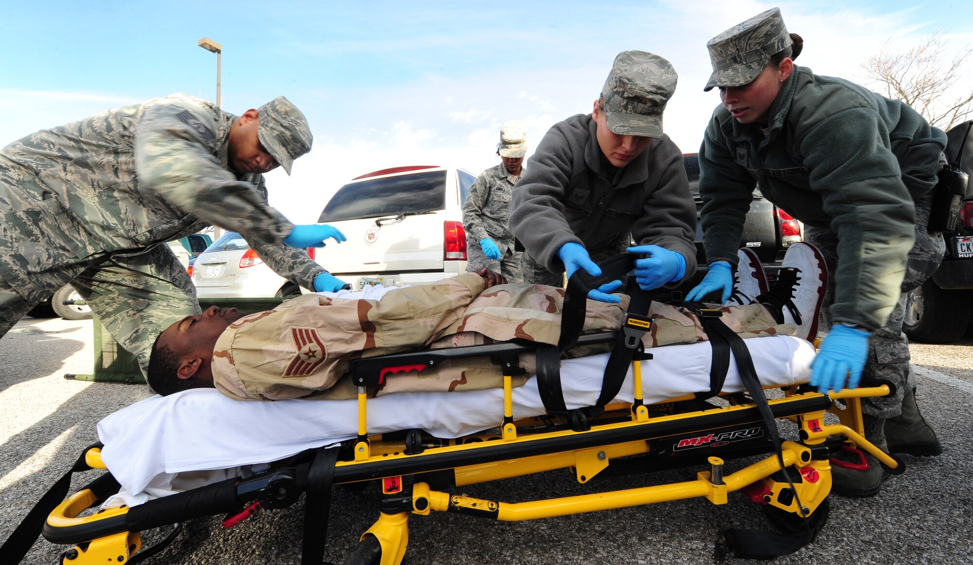 WHITEMAN AIR FORCE BASE, Mo. -- Airmen from the 509th Medical Group place a moulaged victim on a stretcher so he can be evacuated during a Major Accident Response Exercise Feb. 23. The MARE tested Airmen on proper techniques and procedures when responding to a major accident with mass casualties. (U.S. Air Force photo/Senior Airman Nick Wilson)