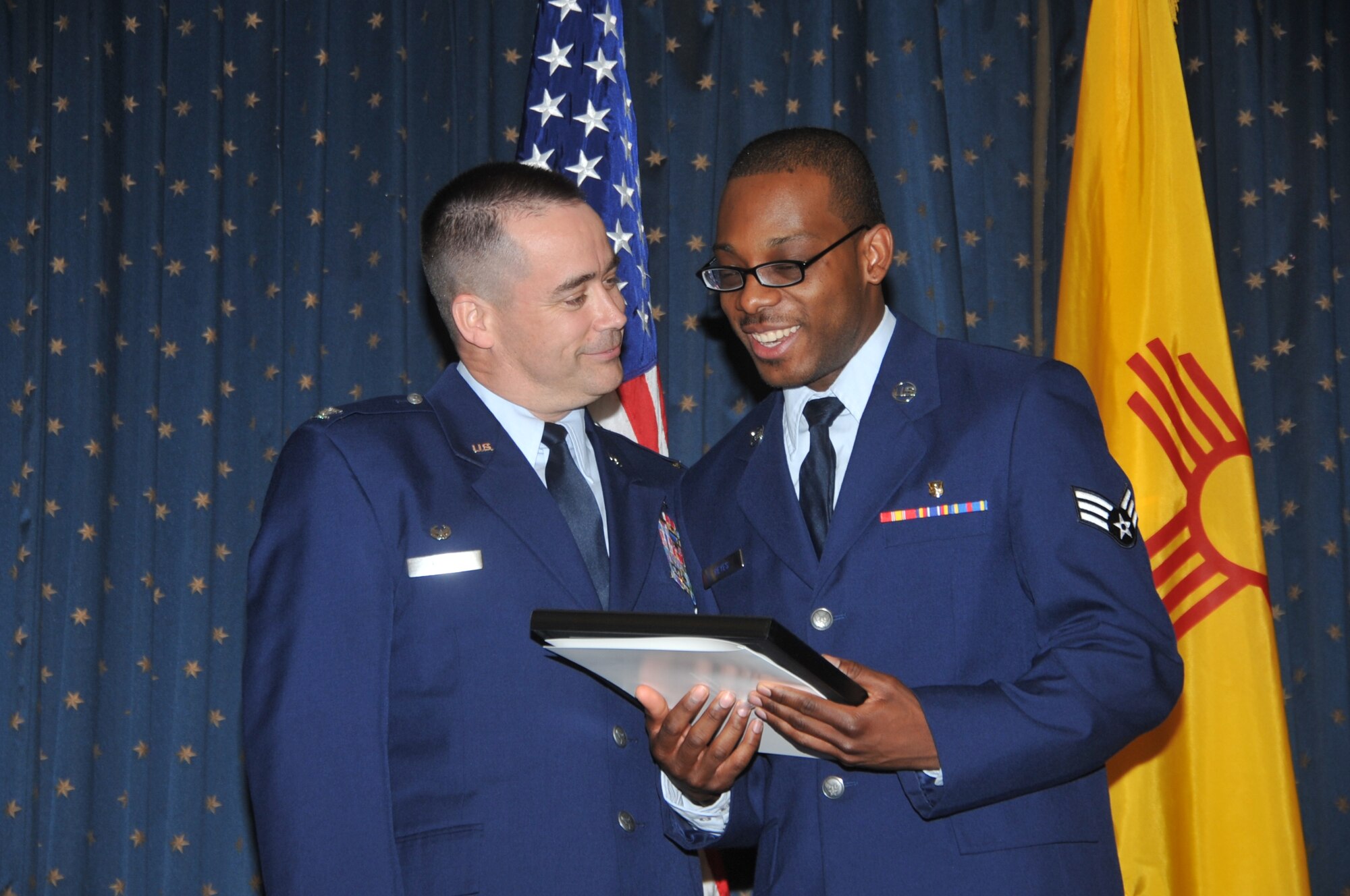 KIRTLAND AFB, N.M. – Senior Airman Raewyn Reyes, 377th Dental Squadron, accepts his certificate of naturalization from Col. Steven Reese, 377th Medical Group commander, during a naturalization ceremony Feb. 29 at the Mountain View Club. Military members with at least one year of service can apply for naturalization under Section 328 of the Immigration and Nationality Act. Reyes, originally from Belize, has been in the Air Force for three years. (Photo by Todd Berenger) 