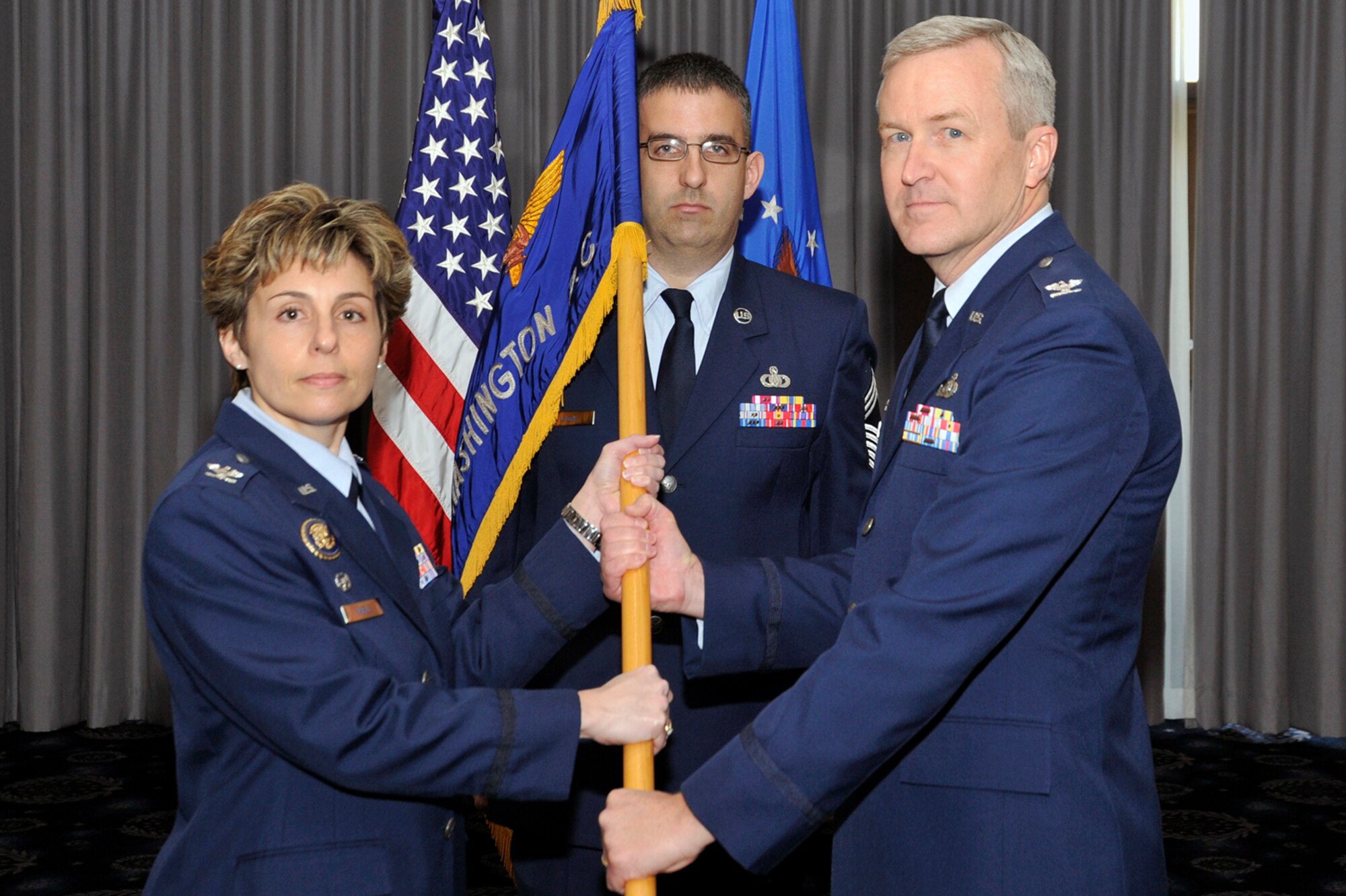 Col. Larry Lang accepts The United States Air Force Band guidon from Col.
Gina Humble, 11th Operations Group commander, during The USAF Band
assumption of command March 6, 2012 at Joint Base Anacostia-Bolling,
Washington, D.C. Lang was the previous U.S. Air Force Academy Band commander
at Peterson Air Force Base, Colo. (U.S. Air Force photo/ Senior Airman Perry Aston)
