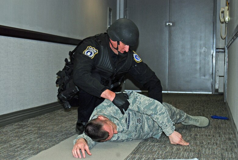 PETERSON AIR FORCE BASE, Colo. — A 21st Security Forces Squadron member checks a casualty for identification during an active shooter scenario, Feb. 29. The scenario was part of the Condor Crest exercise to ensure readiness in case of real world events. (U.S. Air Force photo/Lea Johnson)
