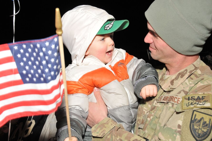 Staff Sgt. Todd Wilkinson listens to and holds his 3-year-old son, Aidan McNamara, shortly after being reunited at Bradley Air National Guard Base in East Granby, Conn. after returning from Afghanistan Feb. 20, 2012. The Air Guardsman is assigned to the 103rd Civil Engineer Squadron and had been deployed since July 2011 with the Expeditionary Prime Base Engineer Emergency Force (BEEF) squadron, performing light construction and facility repair operations including plumbing, interior electric, HVAC, power production and distribution, as well as other engineering tasks.. (U.S. Air Force photos by Tech. Sgt. Erin McNamara\RELEASED)
