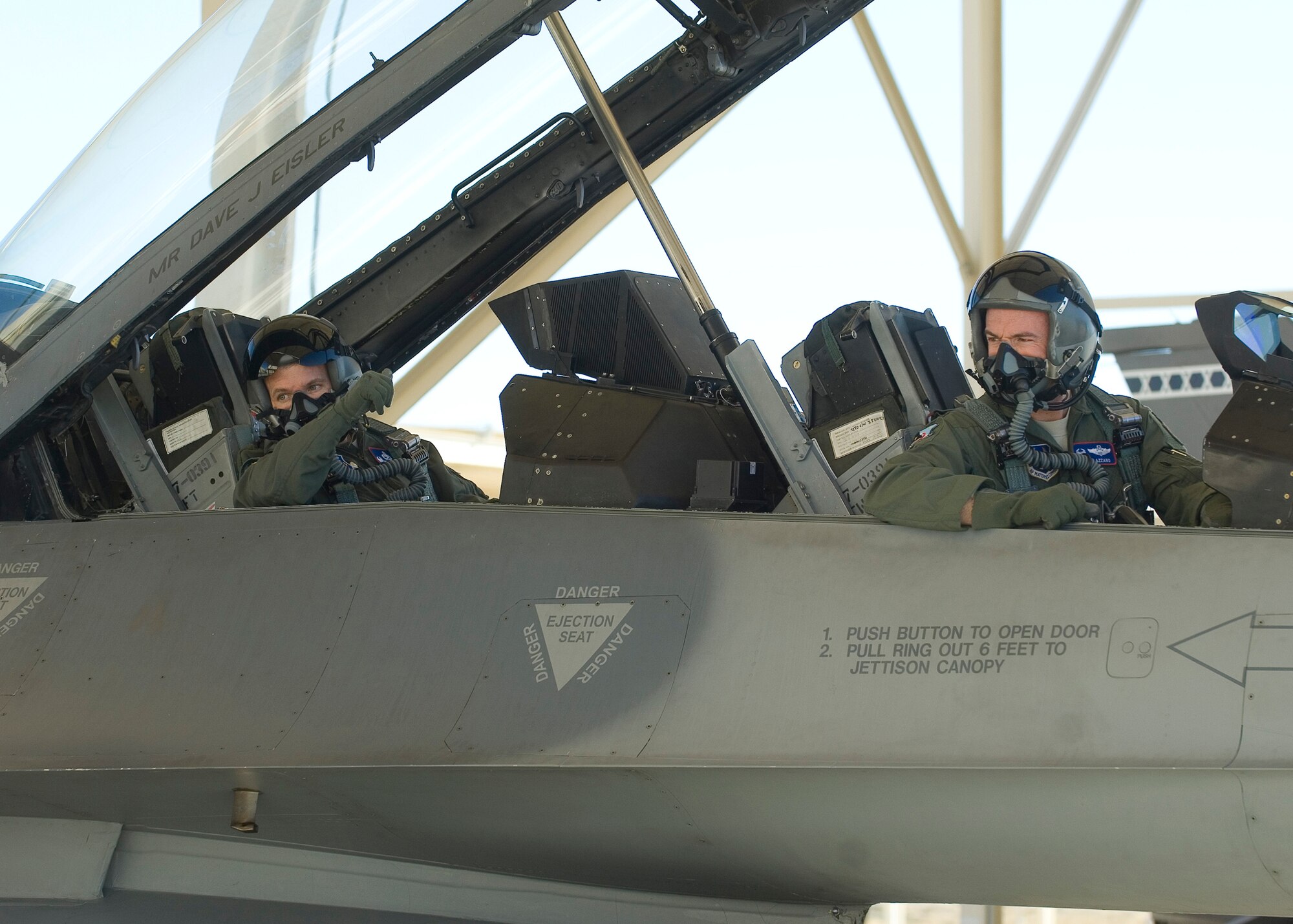 Col. Robert Weaver (left), 412th Maintenance Group commander, and Col. Christopher Azzano, 412th Operations Group commander, look to their crew chief during an engine start before taking part in an actual flight test mission in an F-16 Jan. 13, 2012. This flight marked the first part in an initiative to give operators and maintainers the opportunity to create positive interaction so both gain insight into each other’s work dynamic. That initiative is called the 412th Operations and Maintenance Immersion Program. (U.S. Air Force photo by Rob Densmore)