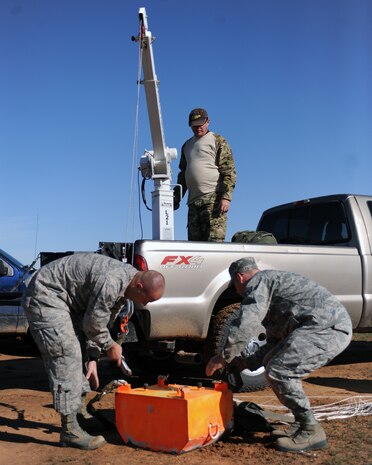 U.S. Air Force Airmen from the 58th Rescue Squadron at Nellis Air Force Base, Nev., load a payload in a truck after finishing their Joint Precision Airdrop System training exercise Feb. 15, 2012, in Eloy, Ariz. These payloads are attached to parachutes that contain JPADS, which enables them to descend from an aircraft on a controlled path to the landing zone. (U.S. Air Force photo by Airman 1st Class Christine Griffiths/Released)