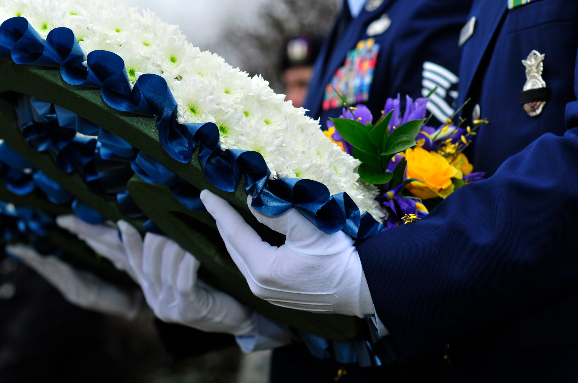 ROYAL AIR FORCE LAKENHEATH, England – Two Airmen of the 48th Security Forces Squadron hold wreaths for fallen comrades during the dedication of the Liberty’s Fallen Defenders Memorial March 2, 2012. The ceremony was held on the one year anniversary of the shooting at Frankfurt International Airport, Germany. A stone monument honoring the memory of 48th Security Forces Squadron Senior Airmen Jason D. Nathan and Nicholas J. Alden was unveiled before more than 250 Airmen and civilians. Nathan was killed in action while deployed to Iraq in June 2007. Alden was killed during the Frankfurt shooting while preparing to deploy to Afghanistan in March 2011. The monument will also serve as a reminder of all Liberty Defenders who have fallen since 2001. (U.S. Air Force photo by Senior Airman Tiffany M. Deuel)