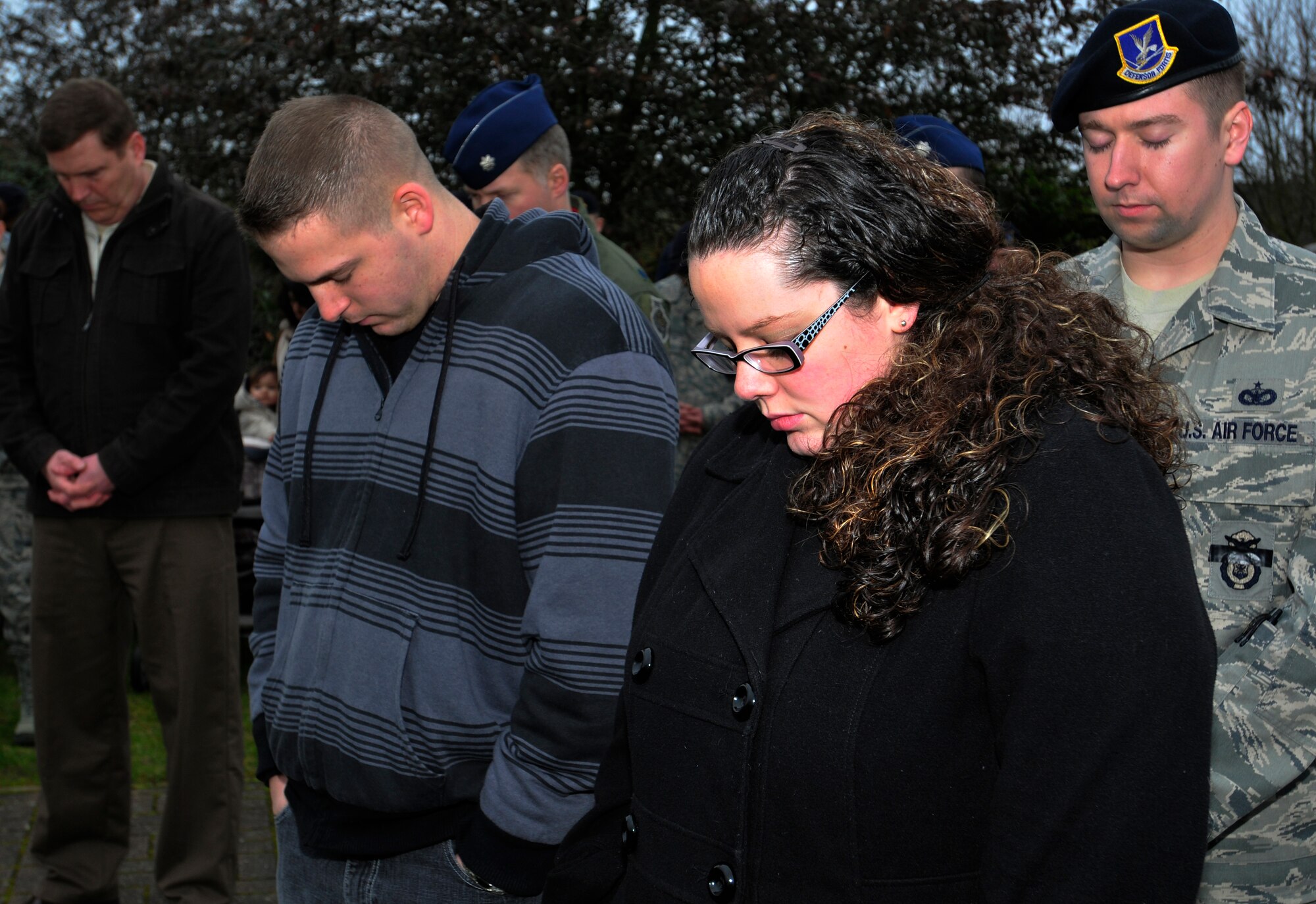 ROYAL AIR FORCE LAKENHEATH, England – Airmen and civilians bow heads in prayer during the dedication of the Liberty’s Fallen Defenders Memorial March 2, 2012. The ceremony was held on the one year anniversary of the shooting at Frankfurt International Airport, Germany. A stone monument honoring the memory of 48th Security Forces Squadron Senior Airmen Jason D. Nathan and Nicholas J. Alden was unveiled before more than 250 Airmen and civilians. Nathan was killed in action while deployed to Iraq in June 2007. Alden was killed during the Frankfurt shooting while preparing to deploy to Afghanistan in March 2011. The monument will also serve as a reminder of all Liberty Defenders who have fallen since 2001. (U.S. Air Force photo by Senior Airman Tiffany M. Deuel)